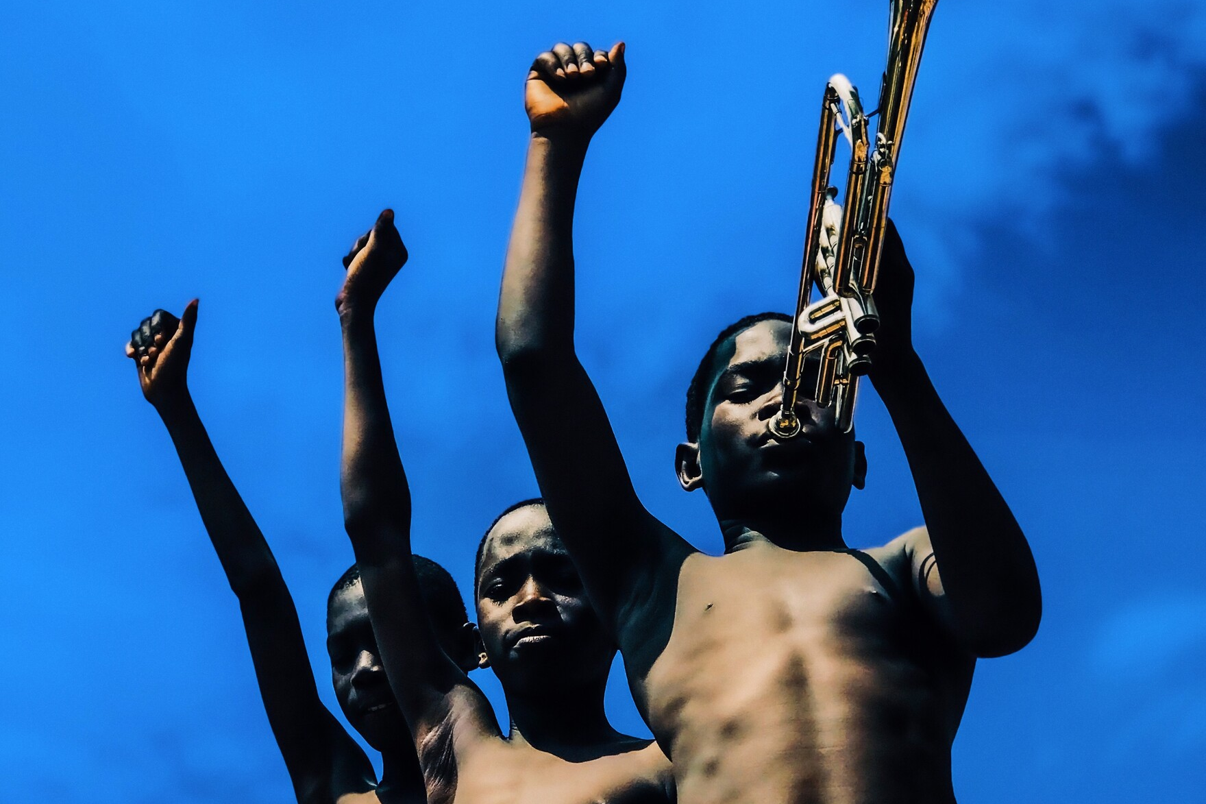 foto van een werk in het kunstmuseum met kinderen die op een trompet spelen